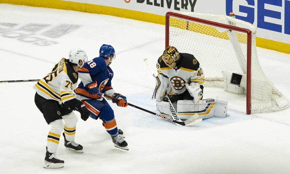 New York Islanders try to shoot on Tuukka Rask