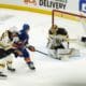 New York Islanders try to shoot on Tuukka Rask