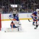Washington Capitals forward T.J. Oshie scoring against New York Islanders netminder Semyon Varlamov (AP)